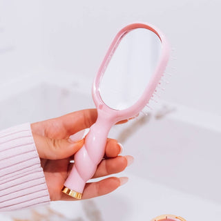 Bubblegum pink mini detangler hair brush by Teleties lifestyle view - House of Me boutique Norman OK