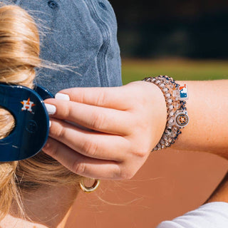 Houston Astros small spiral hair ties by Teleties on wrist - House of Me boutique Norman OK
